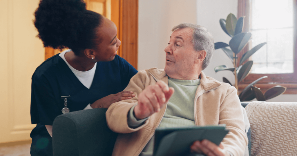 Senior man talks with assisted living nurse