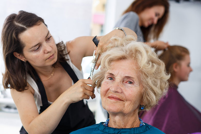 Elderly women getting her hair styled