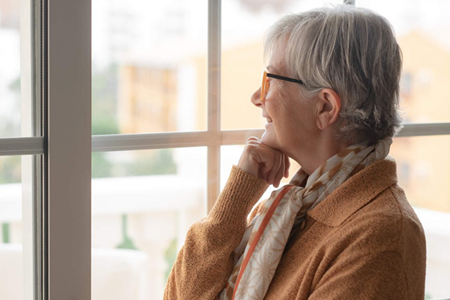 Senior looking out window