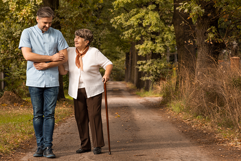 Elderly woman being guided on walk