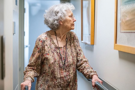 Elderly woman holding onto bar assistance