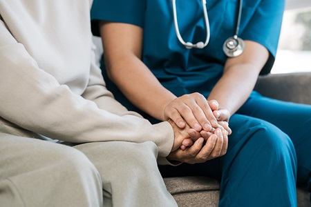 Senior and provider holding hands